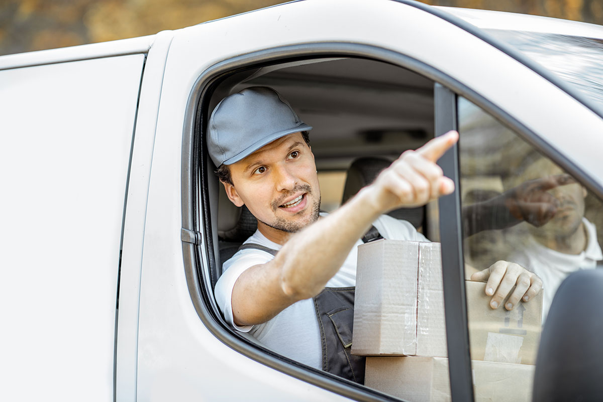 Delivery company employees delivering goods by a car